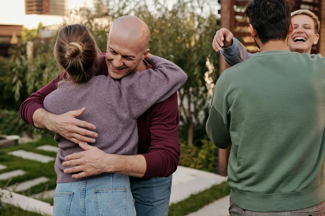 4 Friends hugging each other in a garden